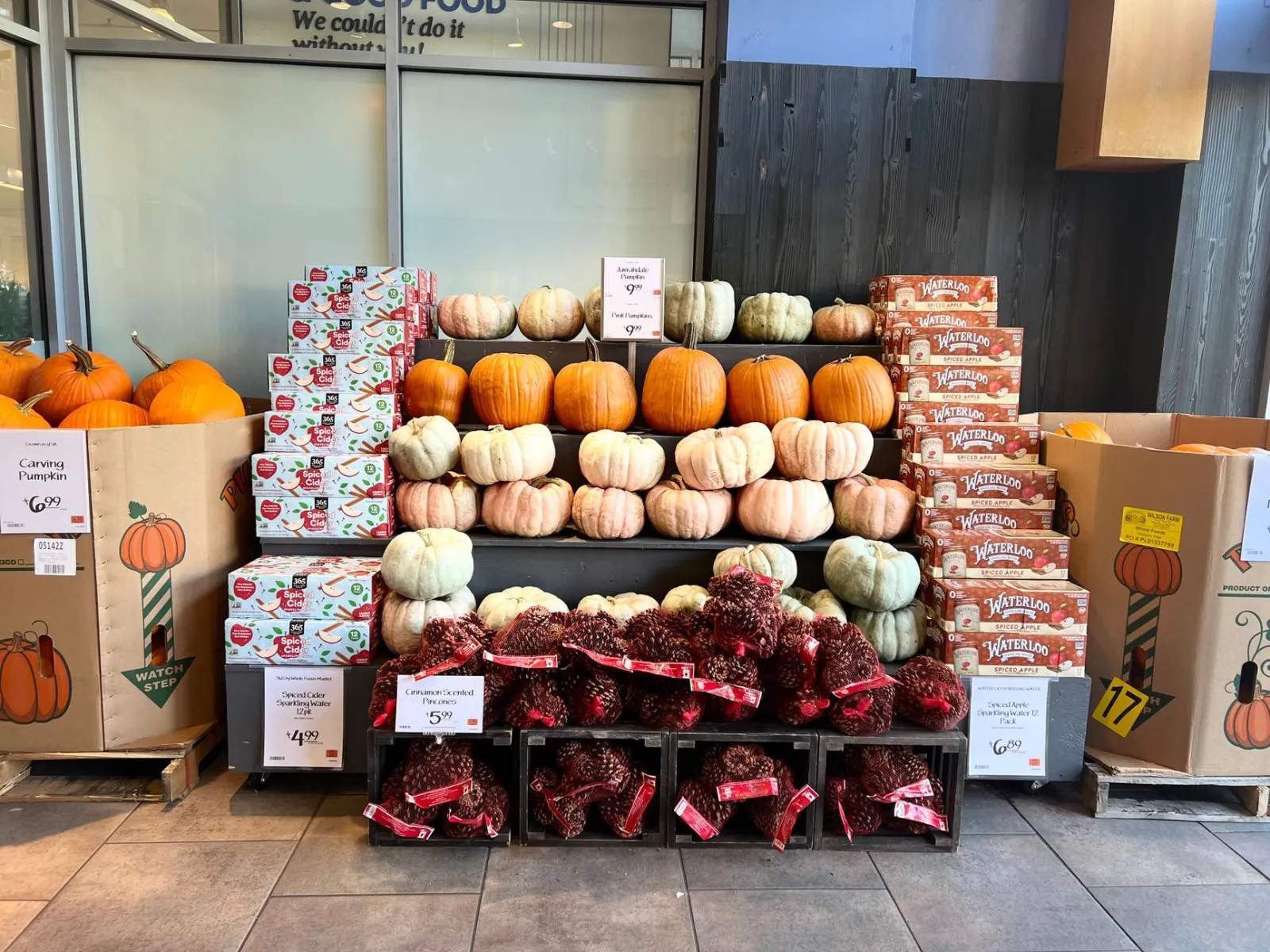 Colorful autumn display with pumpkins and decorative items at a market.