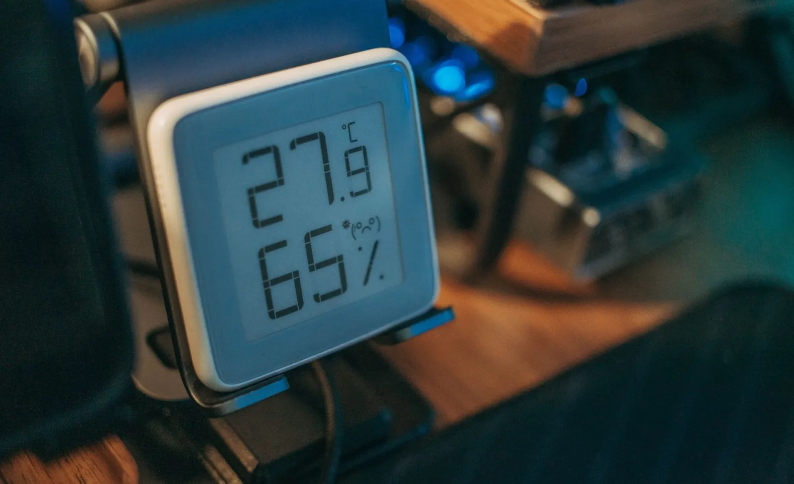 Close-up of a digital hygrometer showing temperature and humidity indoors.